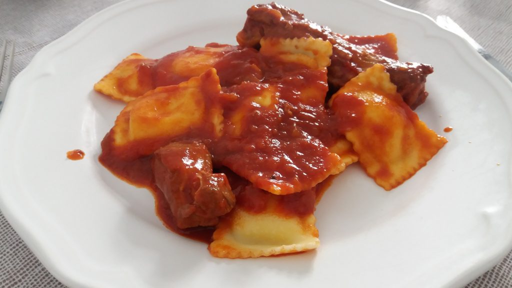 Ravioli with tomato and pork sauce 